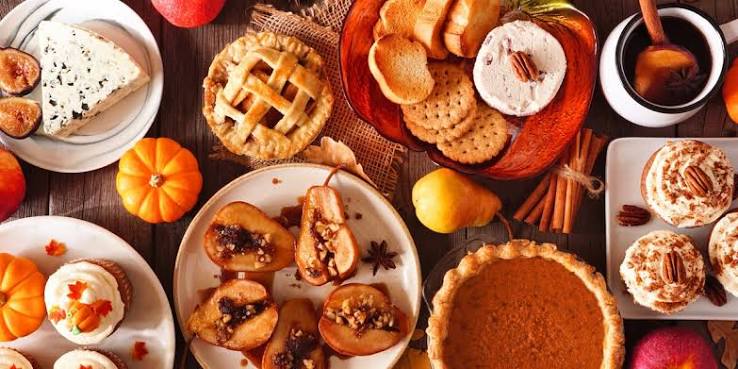 Fall spread of pies, cupcakes, and roasted pears